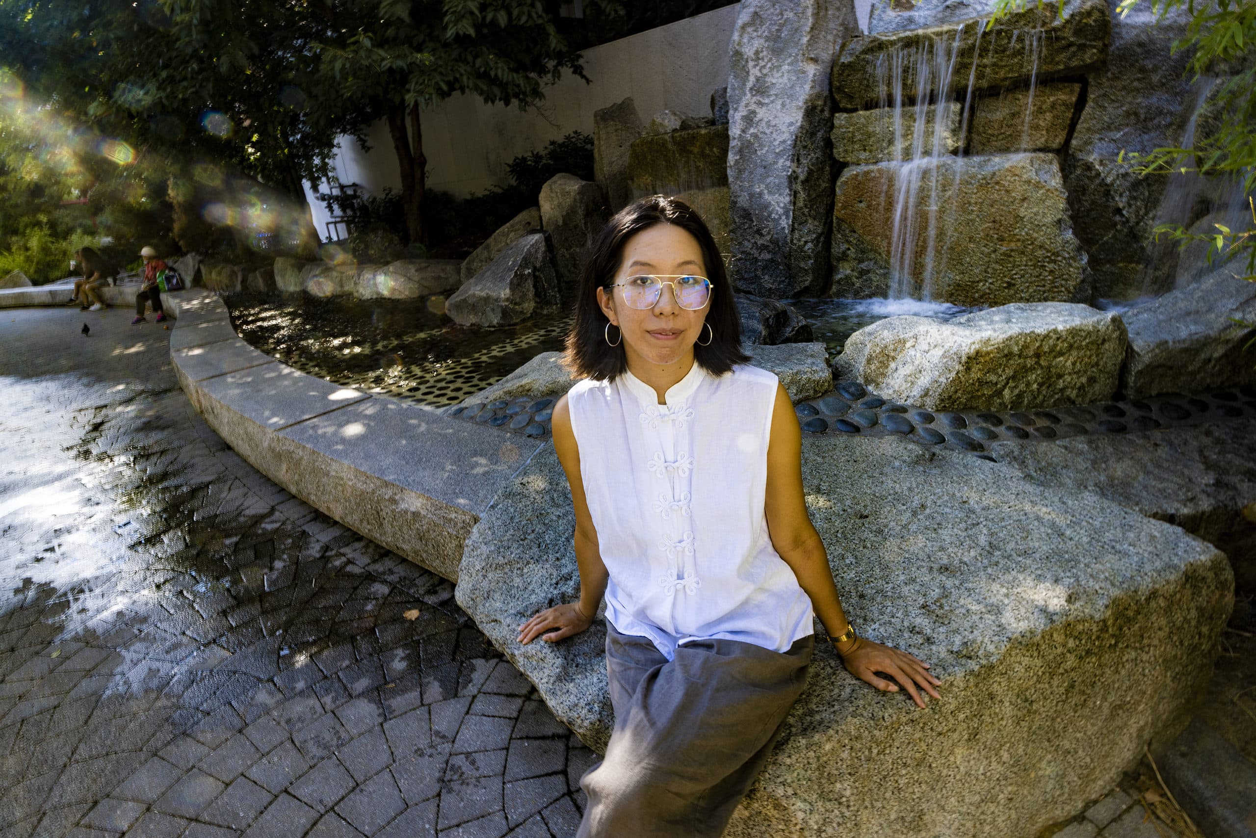Artist Lily Xie at the River Stream Fountain in Chinatown Park on the Rose Kennedy Greenway. (Jesse Costa/WBUR)