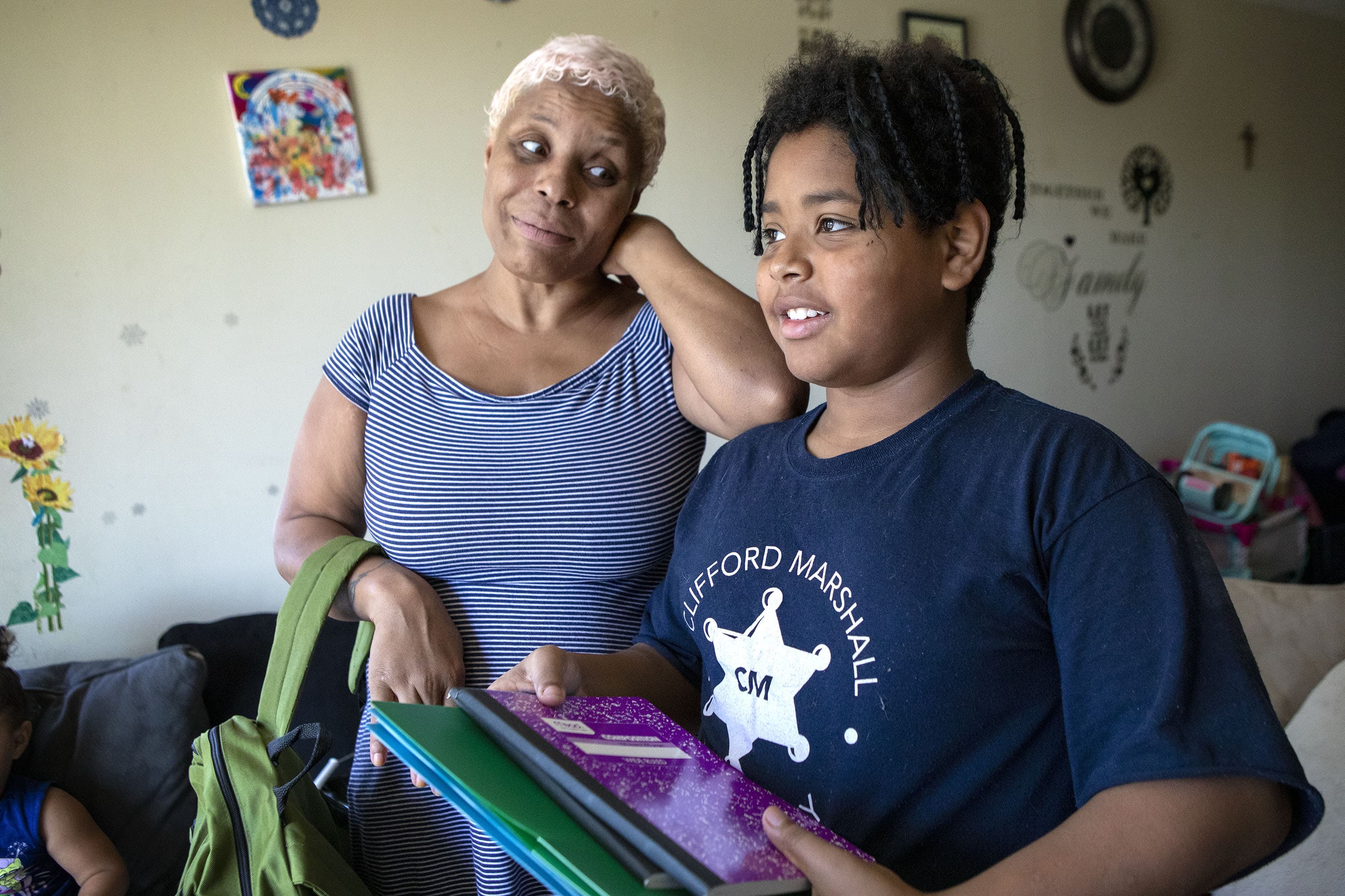 Deonne Luacaw and her son Joshua with some of the school supplies they have purchased for the start of the new school year. (Robin Lubbock/WBUR)