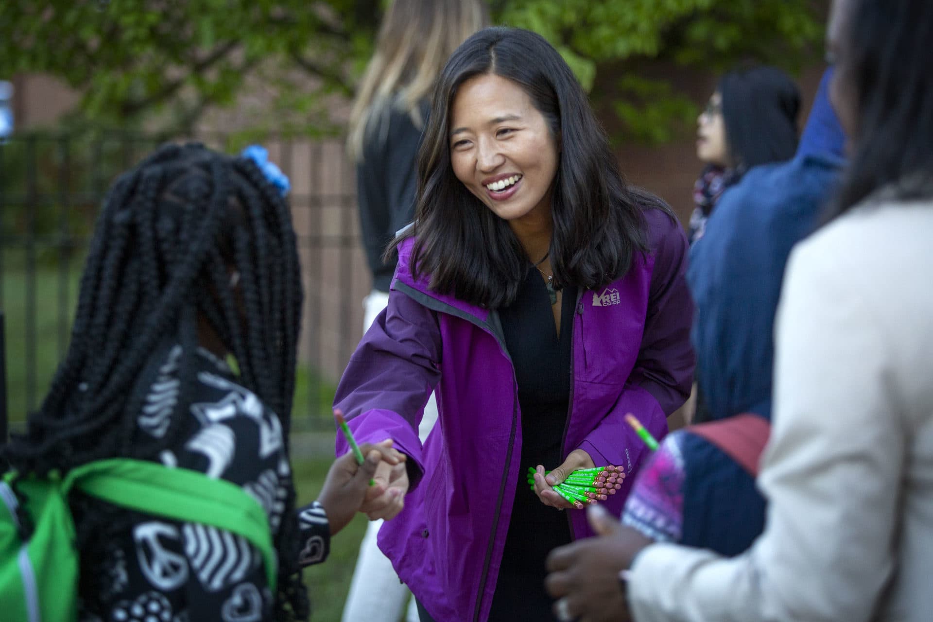 Boston Mayor Michelle Wu welcomes children arriving at Mattahunt Elementary School at the start of the new school year. (Robin Lubbock/WBUR)