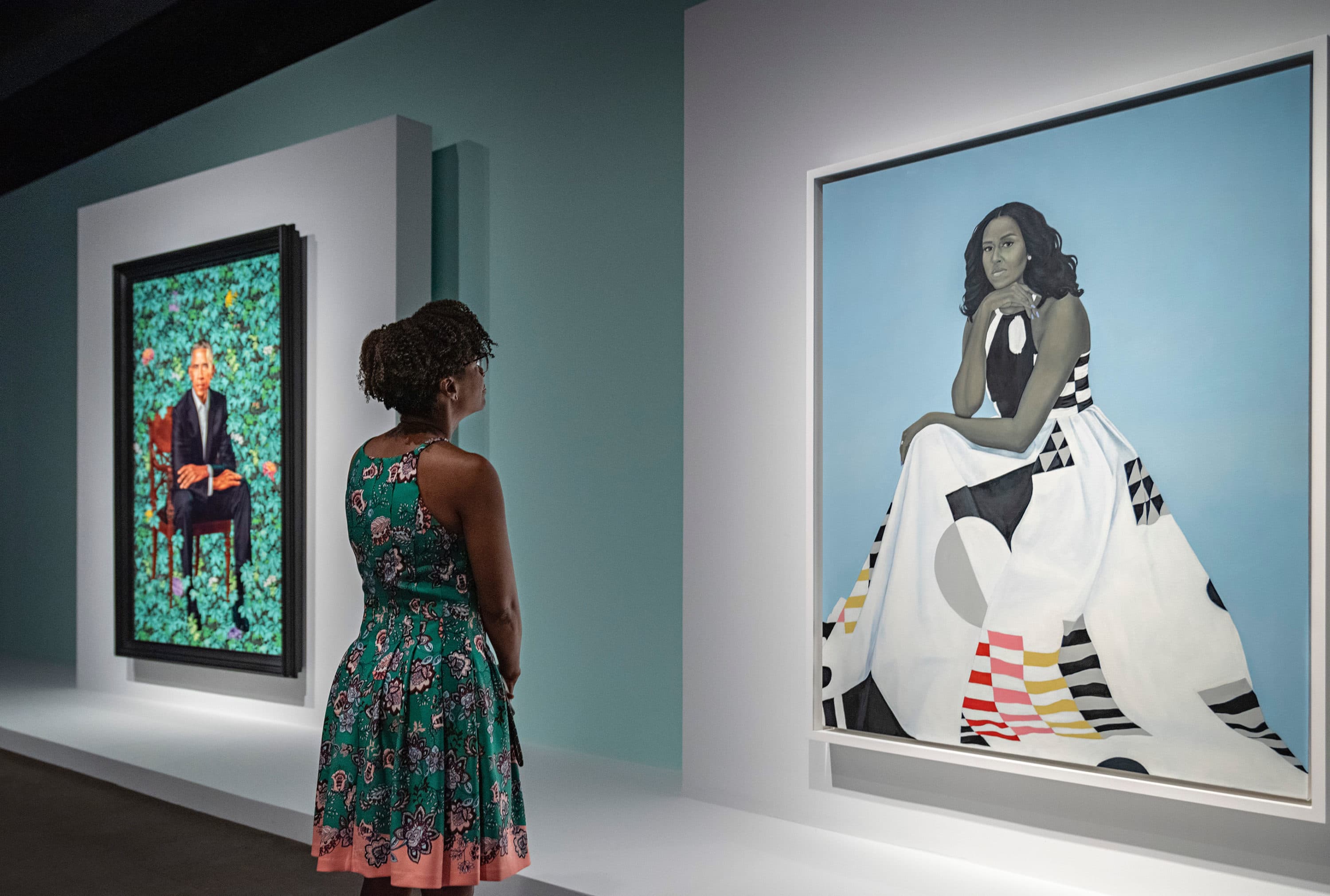 A woman stands before the Obama Portraits Tour exhibition at the Museum of Fine Arts, Boston. (Courtesy Museum of Fine Arts, Boston)