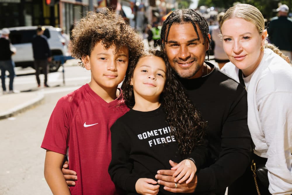 Nildo Silva and his wife, Sarah Fisher, pose with their two children during a "Beautiful Dot" portrait session outside of the Boston Public Library Field's Corner branch on Sept. 24. (Courtesy Mike Ritter)