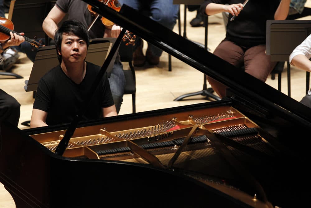Pianist Lang Lang rehearses with chief conductor Charles Dutoit and the Philadelphia Orchestra Wednesday, Oct. 19, 2011 in Philadelphia. Lang, 29 from China, is joining the symphony for three performances of Liszt's famed Piano Concerto No. 1 along with other selections. (Alex Brandon/AP)