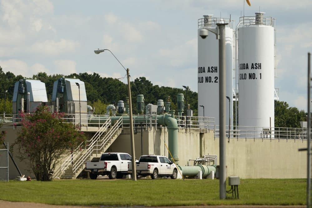 Workmen's vehicles align a portion of the City of Jackson's O.B. Curtis Water Plant in Ridgeland, Mississippi., where an emergency rental pump was installed. (Rogelio V. Solis/AP)