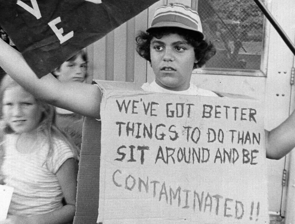 In this Aug. 5, 1978 file photo, Mark Zanatian, one of the children endangered by the Love Canal Chemicals under 99th Street, waves a banner in protest during a neighborhood protest meeting in Niagara Falls, N.Y. New York's top court ruled Thursday, Dec. 15, 2011 that the state can require polluted Superfund sites to be returned to pre-industrial conditions, a win for environmentalists. The Court of Appeals says the state Department of Environmental Conservation can require polluters to restore sites to a level the judges call &quot;complete cleanup.&quot; (AP)