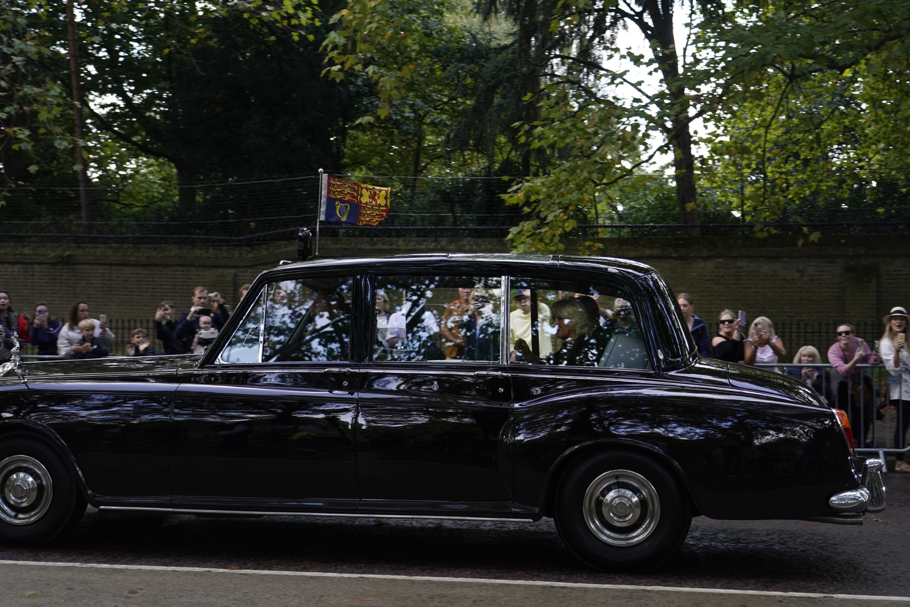 The car carrying King Charles III and Camilla, the Queen Consort, heads to Buckingham Palace in London, Sept. 9. (Alberto Pezzali/AP)
