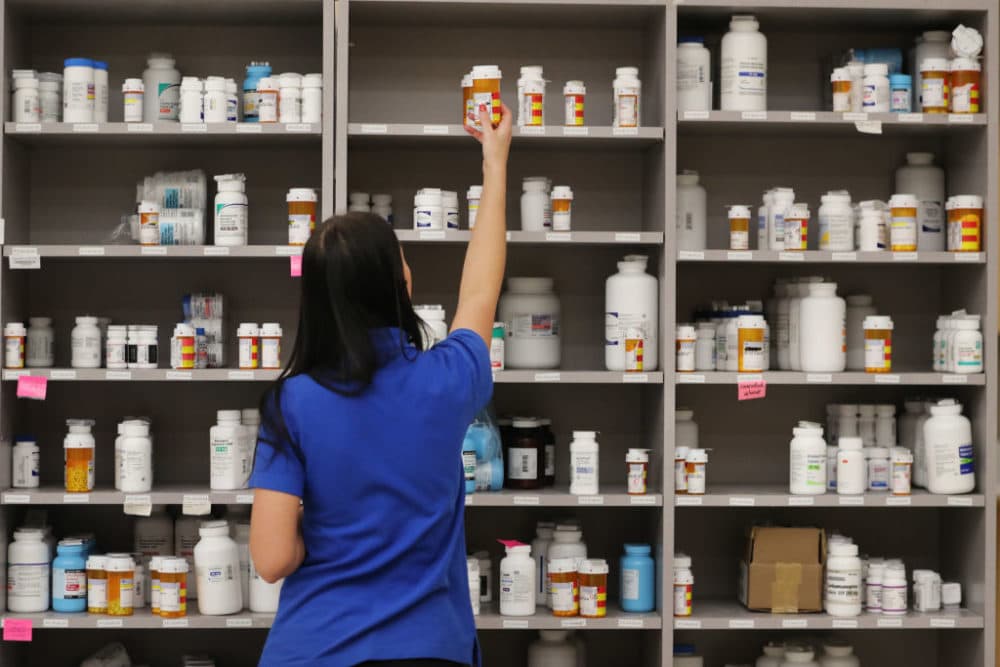 A pharmacy technician grabs a bottle of drugs off a shelve at the central pharmacy of Intermountain Heathcare on Sept. 10, 2018 in Midvale, Utah. (George Frey/Getty Images)