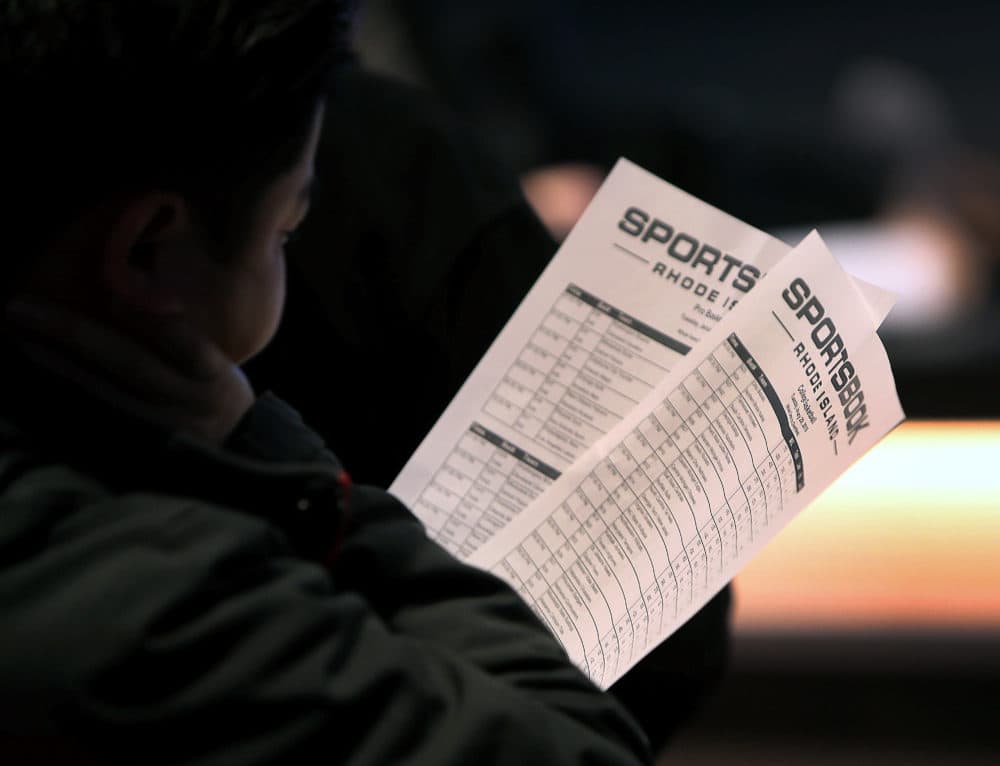 A customer holds sheets with betting information at the sports book bar at Twin River Casino in Lincoln, RI on Jan. 29, 2019. (Photo by Barry Chin/The Boston Globe via Getty Images)