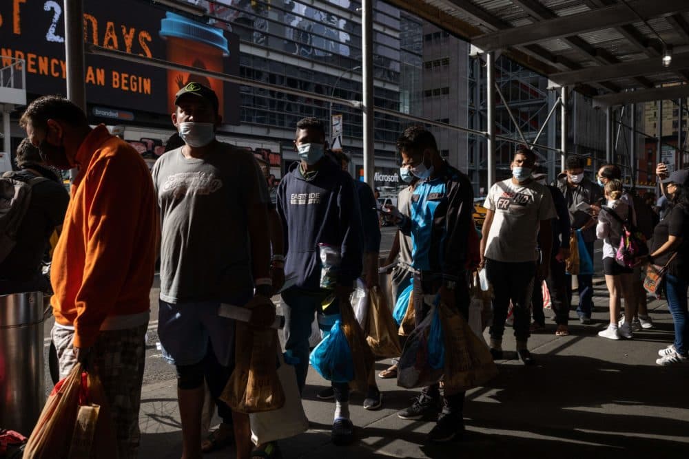 A group of migrants wait in line after arriving from Texas, outside Port Authority Bus Terminal to receive humanitarian assistance on Aug. 10, 2022 in New York. Texas has sent thousands of migrants from the border state into Washington, DC, New York City, and other areas. (Yuki Wamura/AFP via Getty Images)
