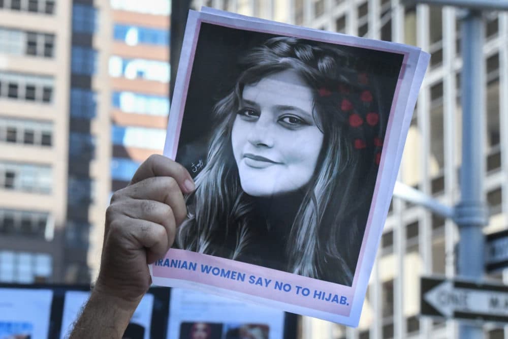 People hold up a photo of Iranian woman Mahsa Amini as they participate in a protest against Iranian President Ebrahim Raisi outside of the United Nations on Sept. 21, 2022 in New York City. (Stephanie Keith/Getty Images)