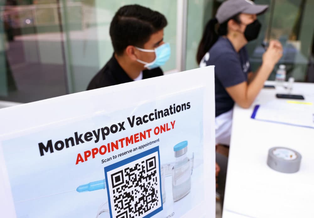 Health workers sit at a check-in table at a pop-up monkeypox vaccination clinic which was opened by the Los Angeles County Department of Public Health on Aug. 3. (Mario Tama/Getty Images)