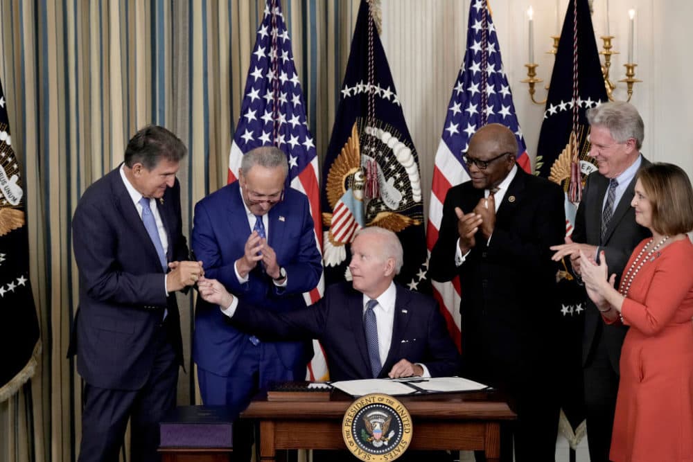 U.S. President Joe Biden (C) hands a pen to Sen. Joe Manchin (D-WV) (L) after signing The Inflation Reduction Act with Senate Majority Leader Charles Schumer (D-NY), House Majority Whip James Clyburn (D-SC), Rep. Frank Pallone (D-NJ) and Rep. Kathy Catsor (D-FL) in the State Dining Room of the White House August 16, 2022 in Washington, DC. (Drew Angerer/Getty Images)