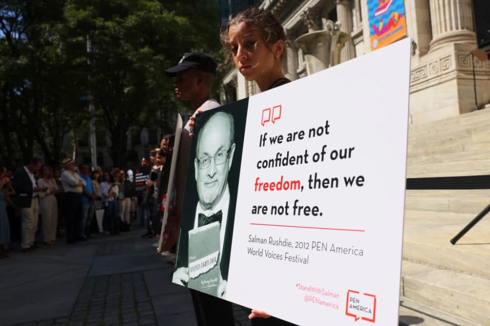 People hold signs as they gather at the steps of the New York Public Library to show support for Salman Rushdie on August 19, 2022 in New York City. Rushdie was attacked and stabbed multiple times while giving a talk at the Chautauqua Institution. (Michael M. Santiago/Getty Images)