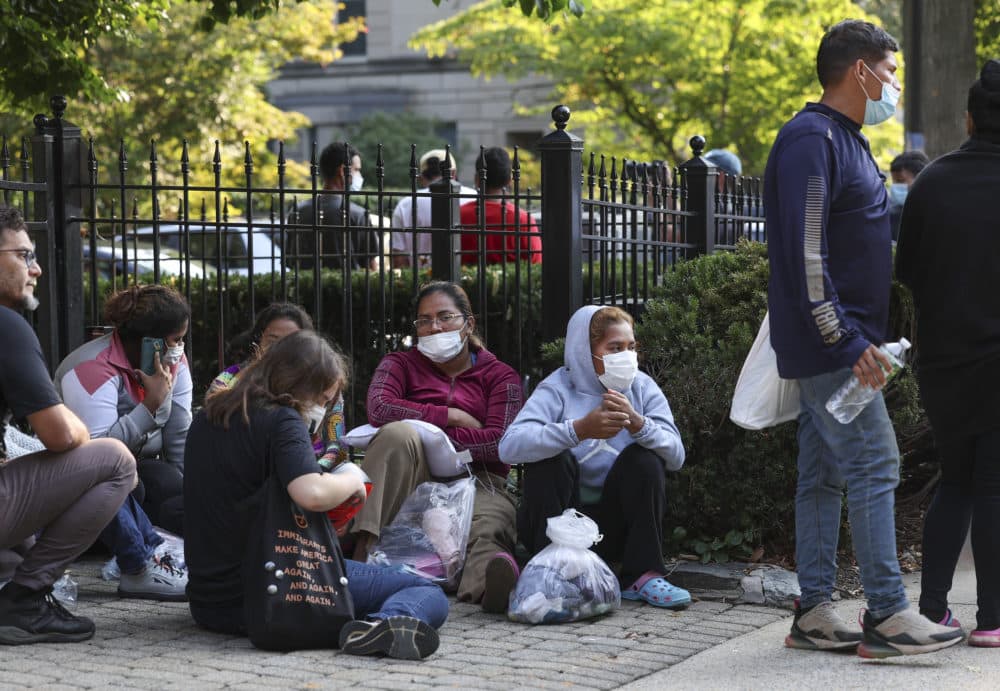 Migrants from Central and South America wait near the residence of U.S. Vice President Kamala Harris after being dropped off on September 15, 2022 in Washington, DC. (Kevin Dietsch/Getty Images)