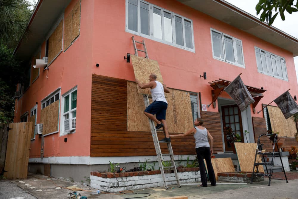 Edward Montgomery and Courtney Viezux board up Montgomery's apartment building as they prepare for the possible arrival of Hurricane Ian on Sept. 27, 2022 in St Petersburg, Florida. (Joe Raedle/Getty Images)