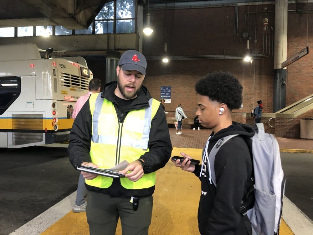 A BPS ambassador helps direct a Boston Public Schools student at the Forest Hills T stop on the first day of school. (Carrie Jung/WBUR)