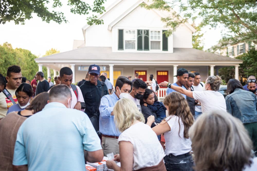 Migrants unexpectedly flown to Martha's Vineyard on Wednesday gathered outside St. Andrew's Episcopal Church in Edgartown. (Ray Ewing/The Vineyard Gazette)