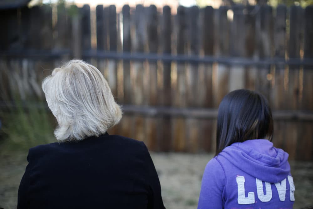 MJ and her adoptive mother sit for an interview in Sierra Vista, Arizona. State authorities placed MJ in foster care after learning that her father, the late Paul Adams, sexually assaulted her and posted video of the assaults on the Internet. (Dario Lopez-Mills/AP)