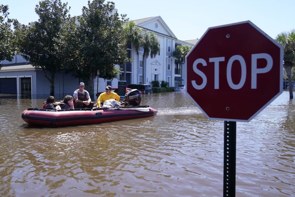 University of Central Florida students are evacuate after apartment complex near the campus was totally flooded by rain from Hurricane Ian on Friday, in Orlando. (John Raoux/AP)