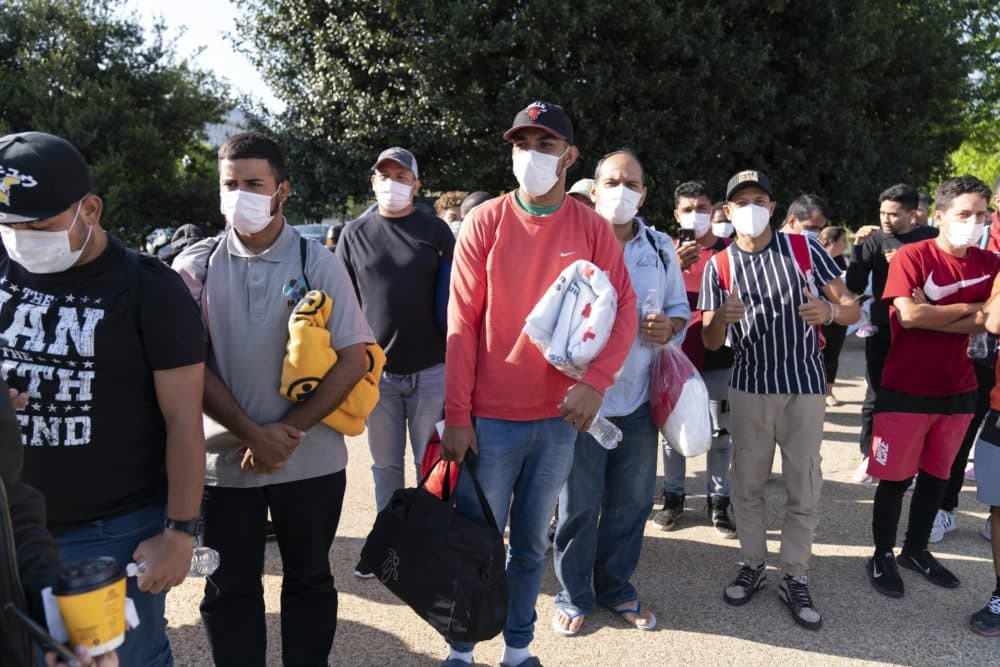 Migrants hold Red Cross blankets after arriving at Union Station near the U.S. Capitol from Texas on buses on April 27, 2022, in Washington. (Jose Luis Magana/AP file photo)