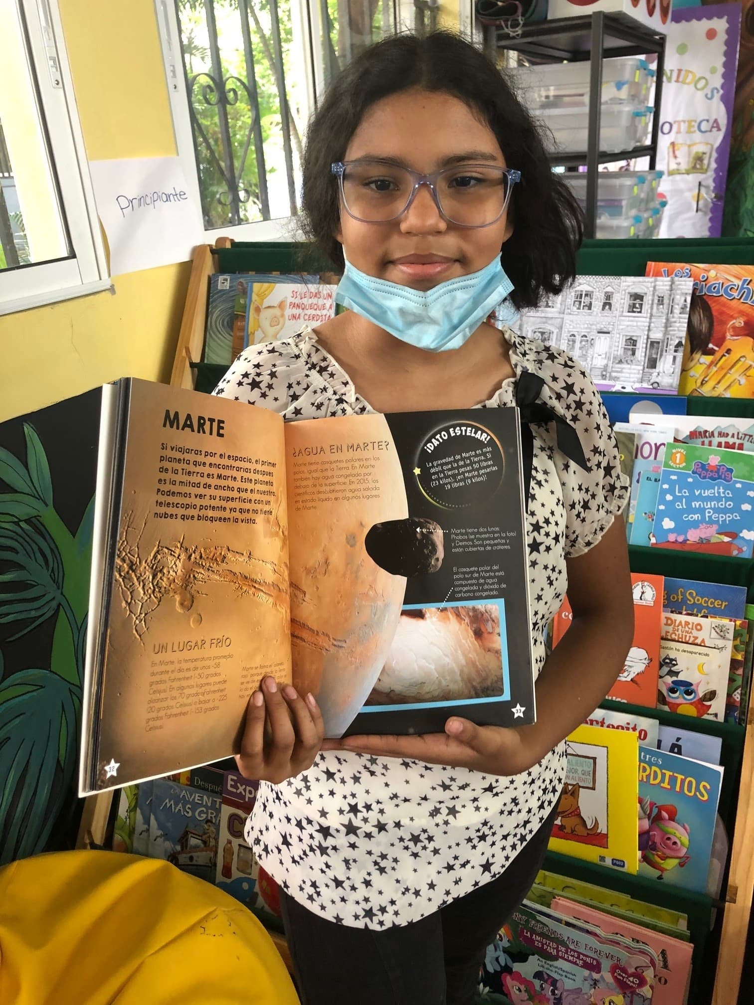 Nasaret Pereira, 11, says she didn't read much before the library came to her school as she didn't have any books at home.  (Karyn Miller-Medzon/Here & Now)