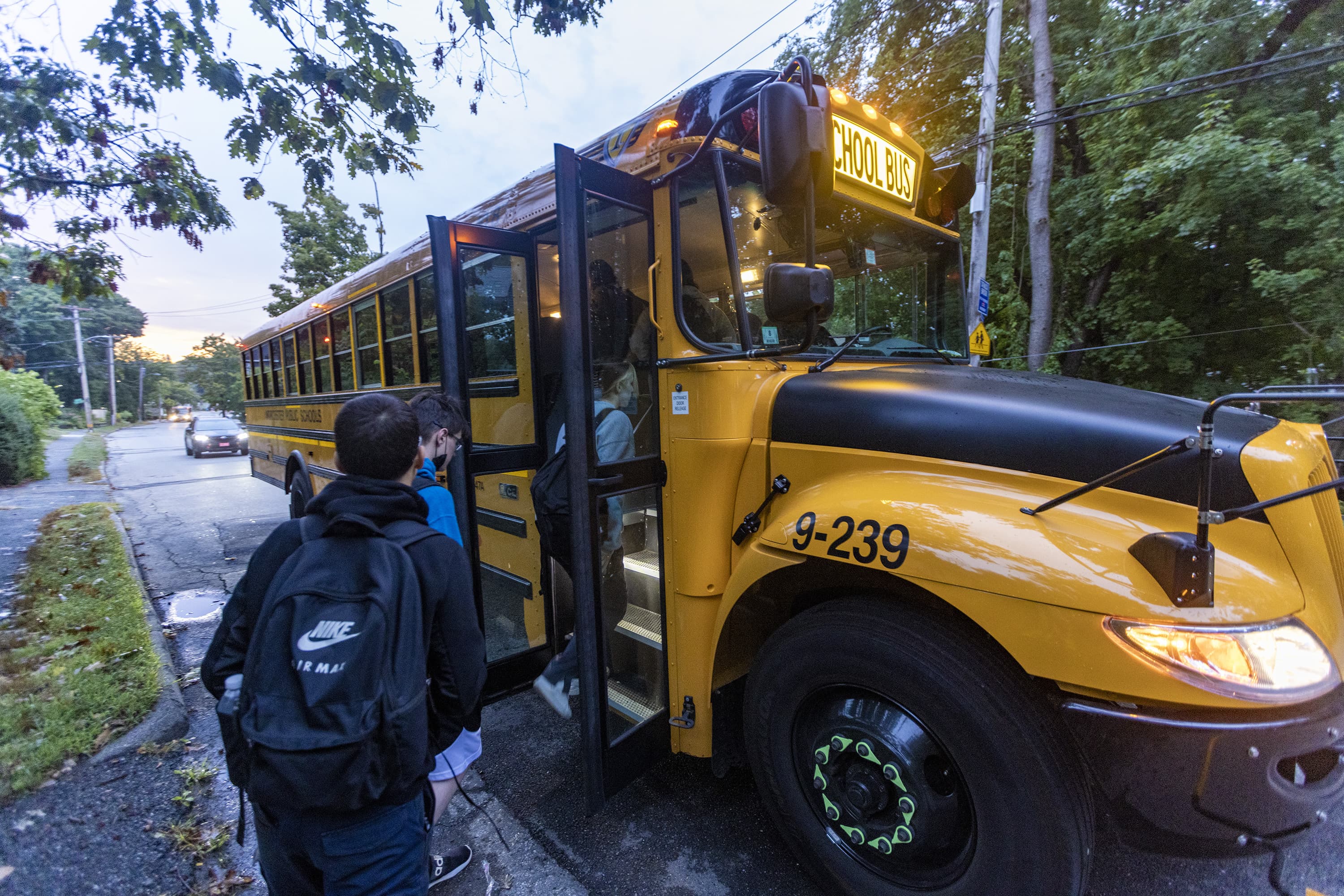 Students from Worcester Technical High School climb aboard a school bus. (Jesse Costa/WBUR)