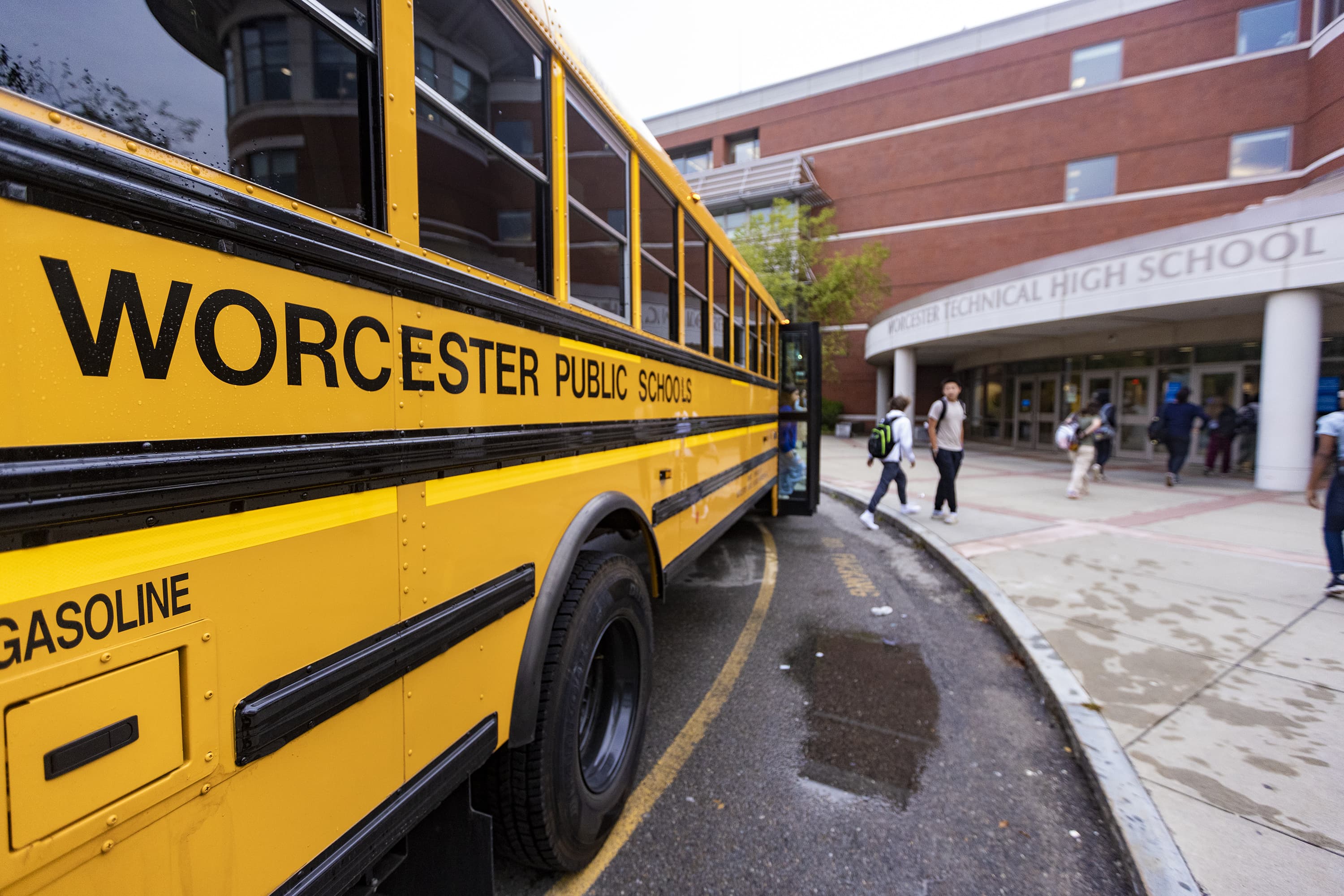 Students get off the school bus and file into Worcester Technical High School. (Jesse Costa/WBUR)