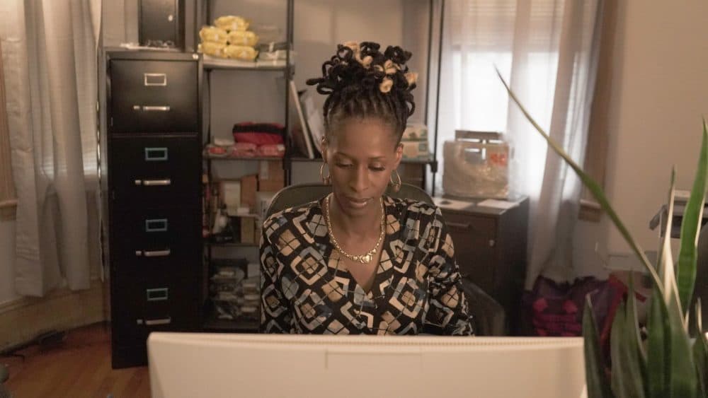 Transgender Emergency Fund executive director Chastity Bowick works through the 84 applications for financial assistance. "We're the only program of its kind here. We need more support." (Arielle Gray/WBUR)