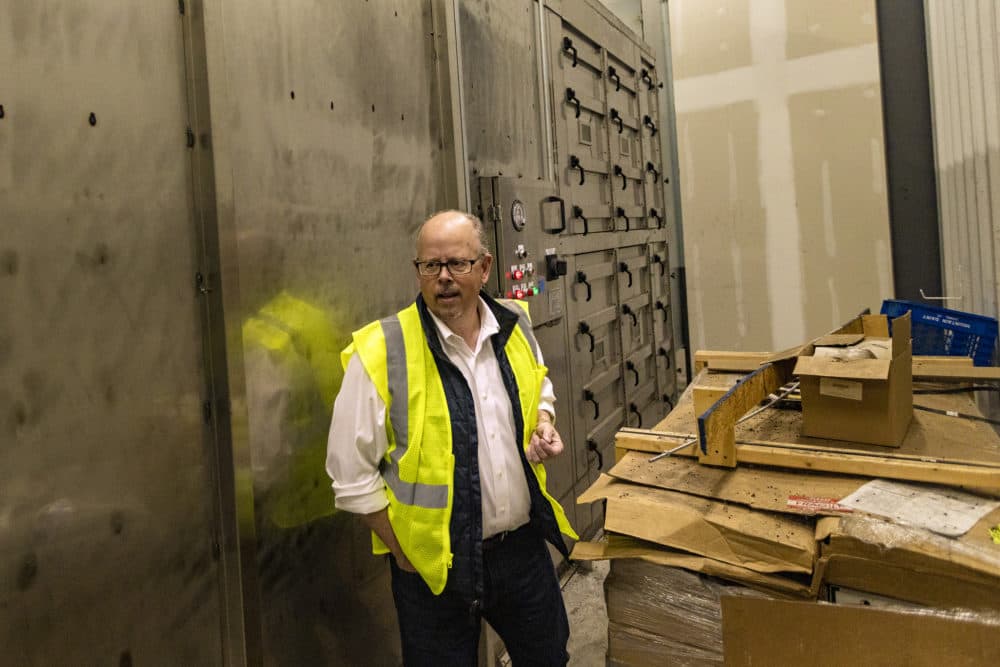 Vanguard Renewables founder and chief strategy officer John Hanselman walks past the filtering system which mitigates the smell of the food waste being processed at the Organics Recycling Facility in Agawam. (Jesse Costa/WBUR)