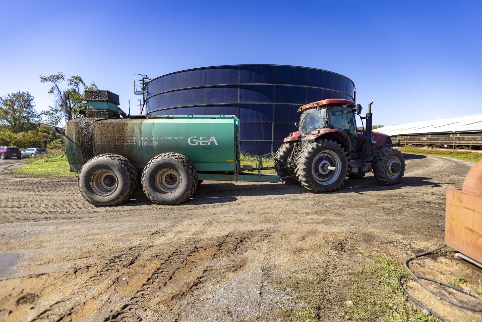 Fertilizer is produced by the anaerobic digester and stored in large blue tanks to be applied to crops at the Bar-Way Farm in Deerfield. (Jesse Costa/WBUR)