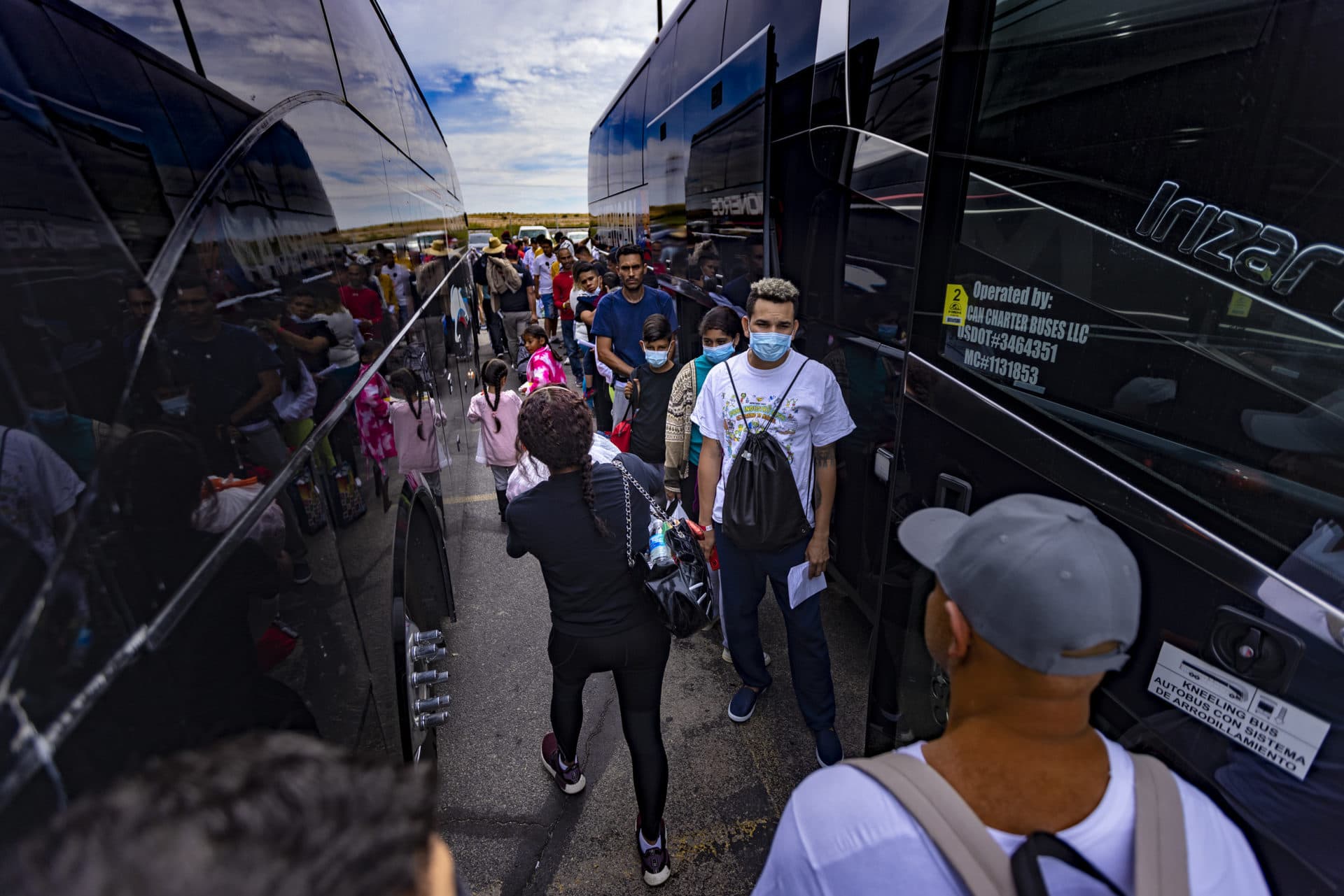 Immigrants prepare to board a charter bus bound for Chicago at the Immigration Welcome Center in El Paso. (Jesse Costa/WBUR)