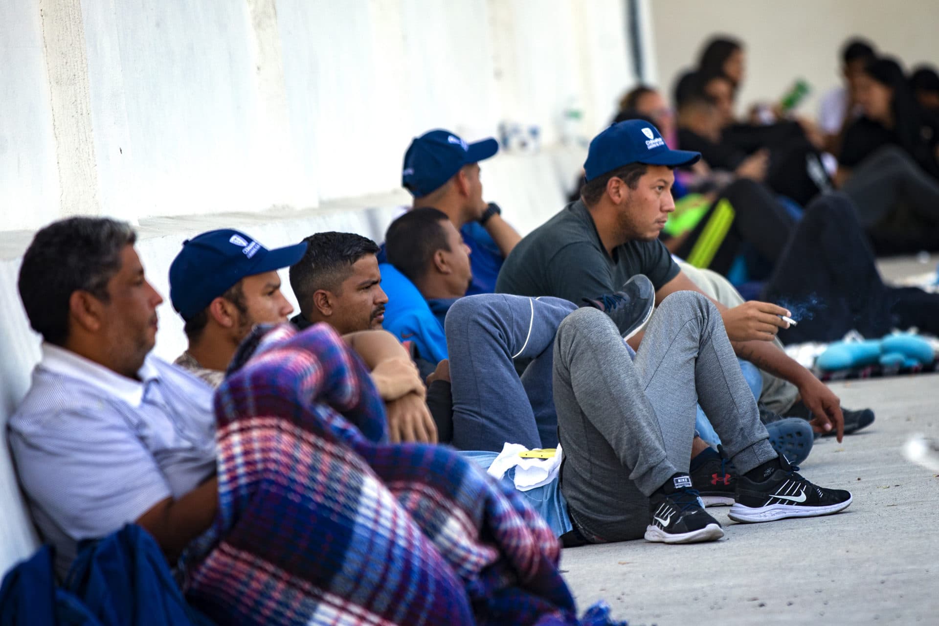 Hundreds of Venezuelan immigrants wait at the Ciudad Jaurez office of Consejo Estatal de Población, (COESPO) the State Population Council in Chihuahua, unable to cross the border into the U.S. (Jesse Costa/WBUR)
