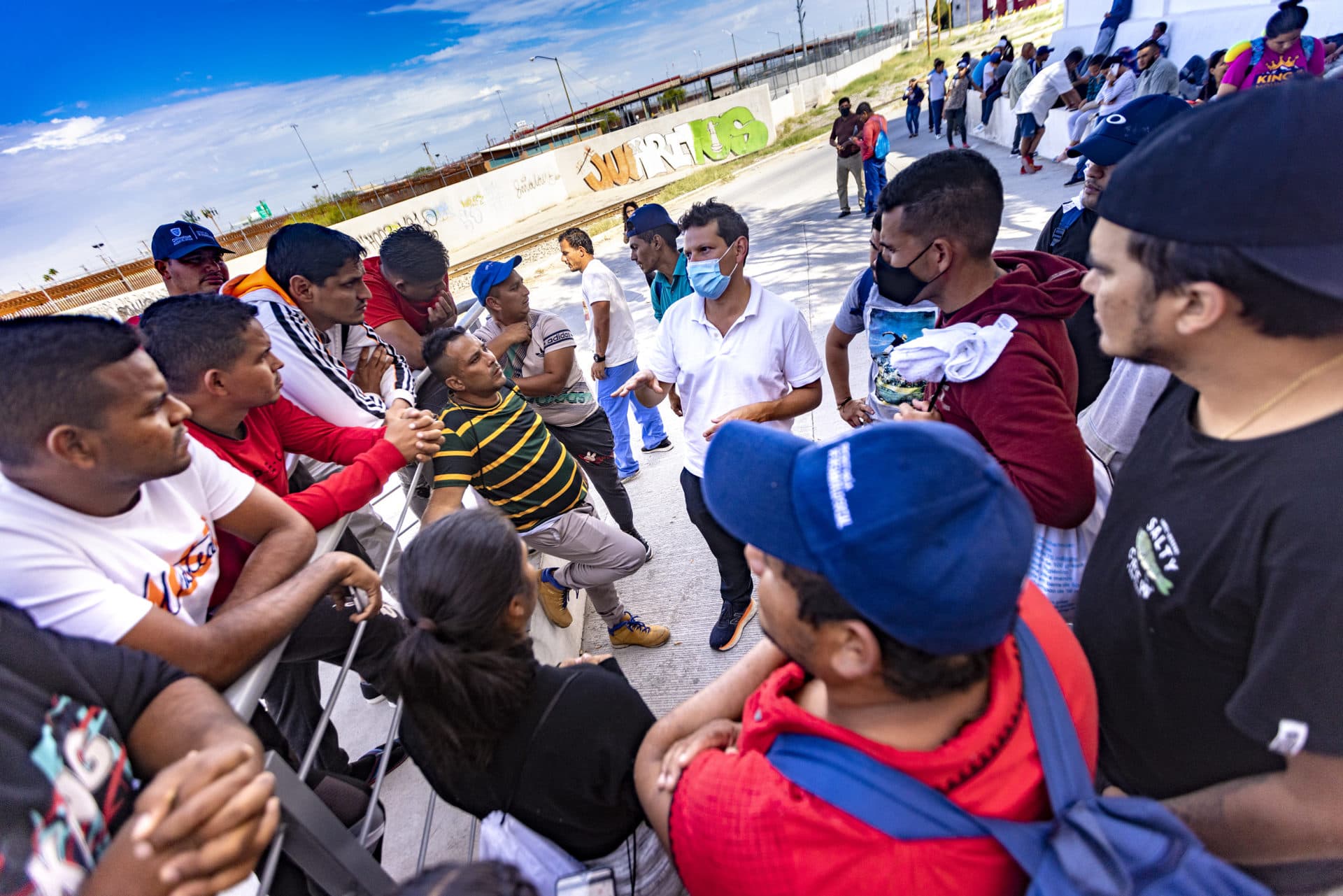 Lawyers for Civil Rights Executive Director, Iván Espinoza-Madrigal, speaks with the Venezuelan immigrants in Ciudad Juarez waiting to cross the border into the U.S. listening to their stories and trying to explain what their options are, if any. (Jesse Costa/WBUR)