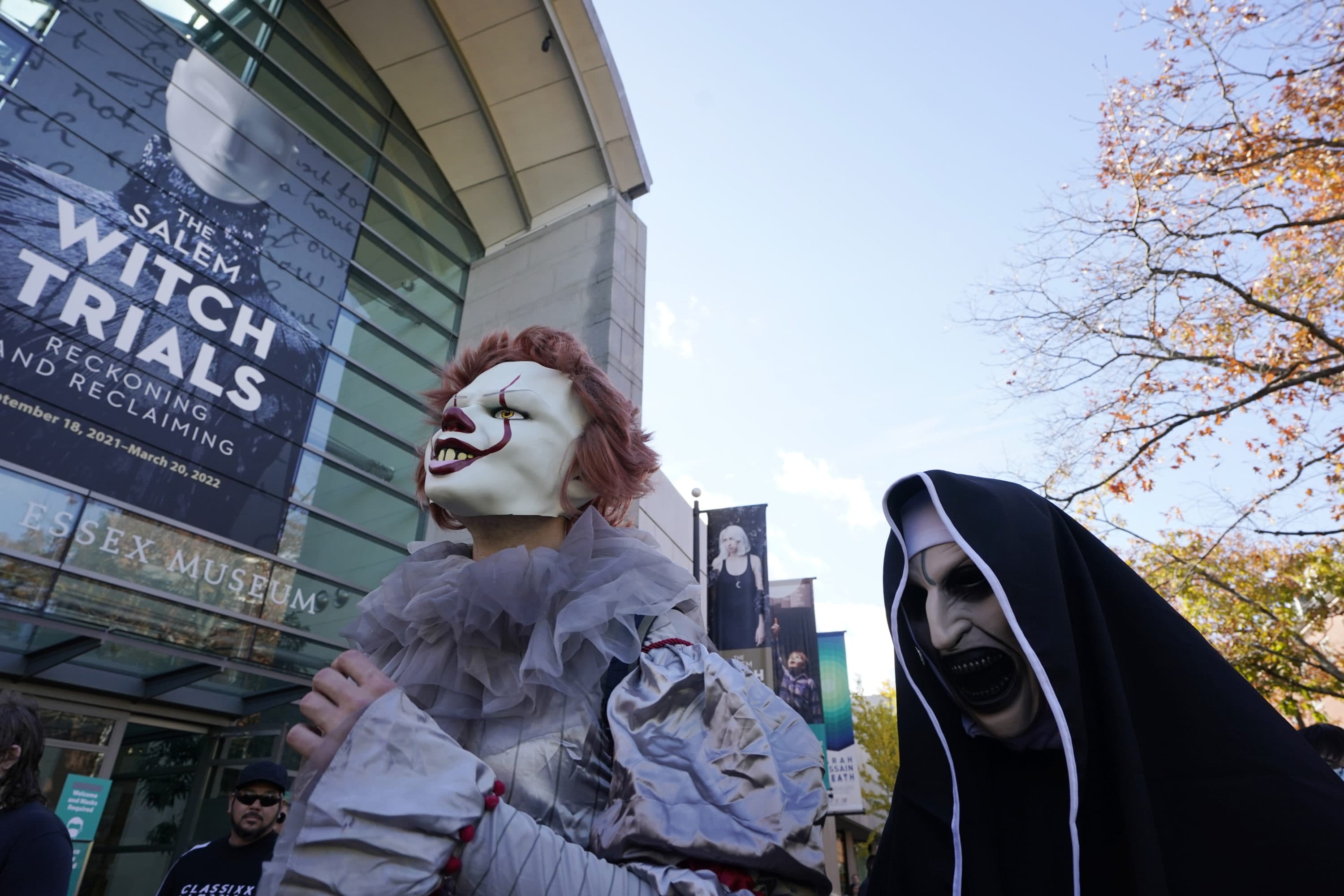 Samuel Aschauen, of Katsdorf, Austria, left, and Rohan Jadau, of Gandhi Nagar, India, right, are dressed in costumes as they promenade through downtown Salem, Mass., on Halloween, Oct. 31, 2021. (Steven Senne/AP)