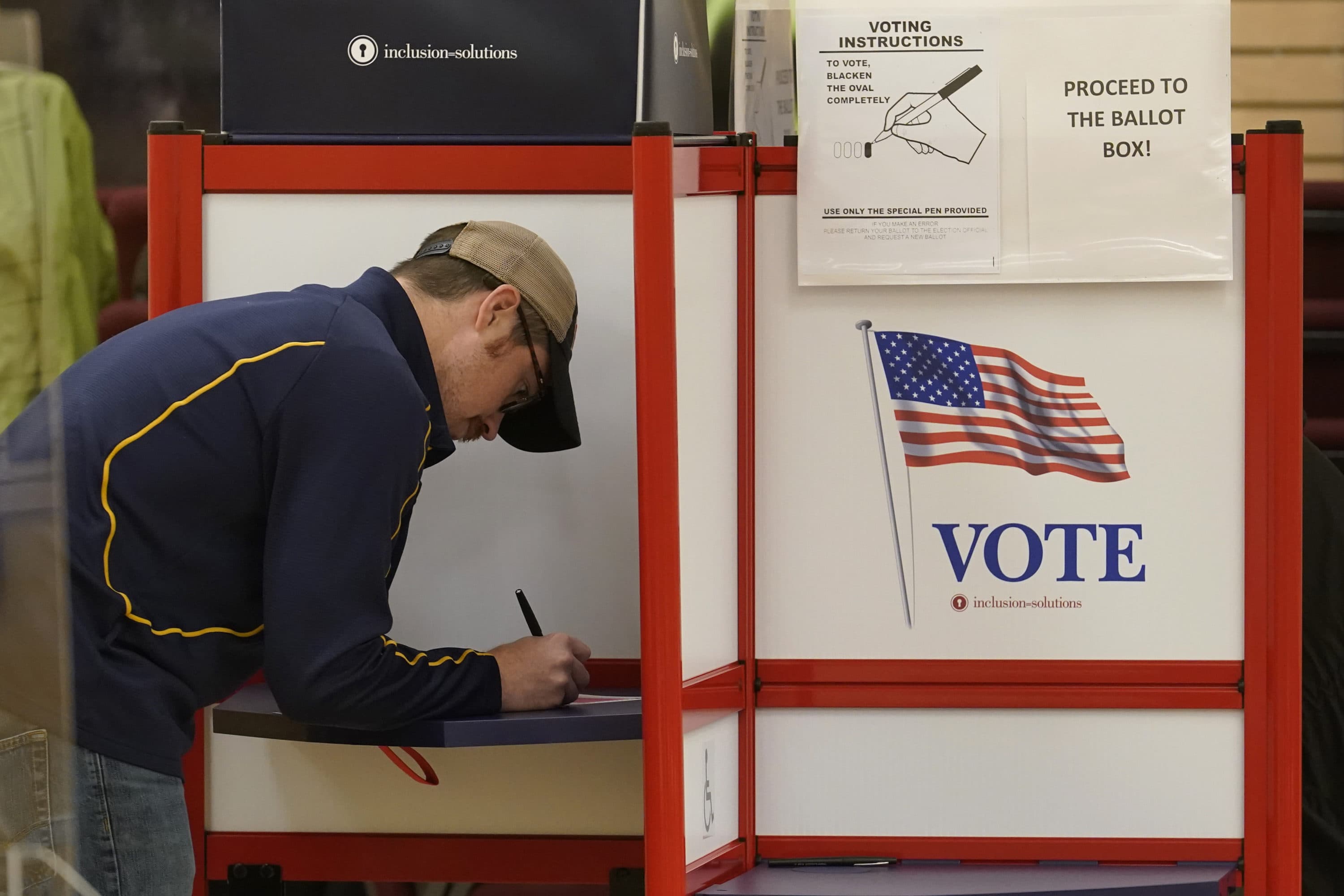 A voter fills out a ballot in the Massachusetts primary election on Sept. 6 at a polling place in Attleboro. (Steven Senne/AP)