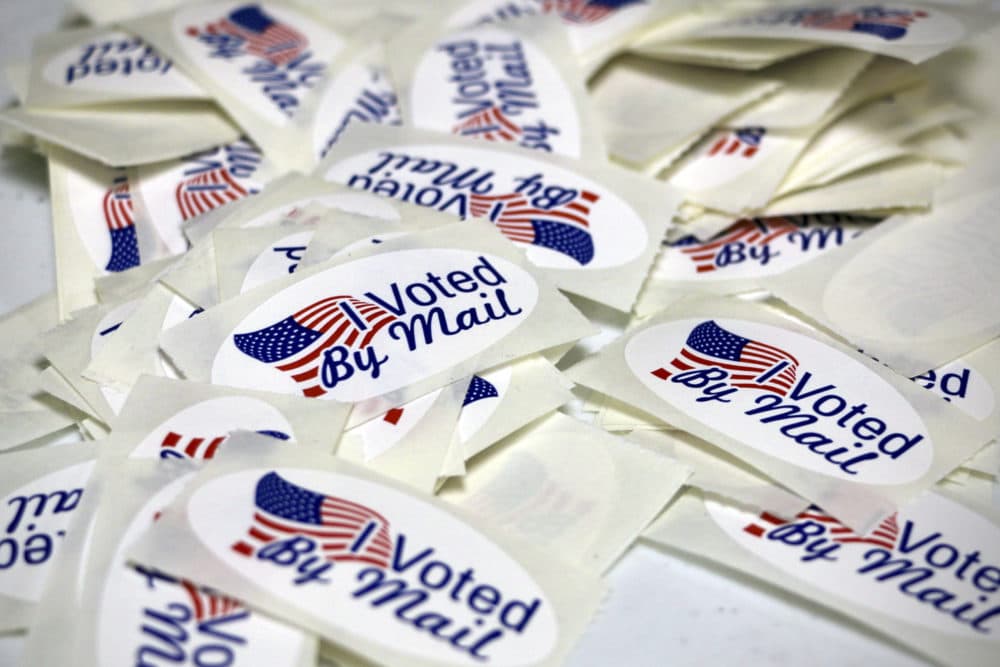 Stickers reading &quot;I Voted By Mail&quot; are displayed as the Wayne County Board of Elections prepares absentee ballots in Goldsboro, N.C., on Sept. 22, 2022. (Hannah Schoenbaum/AP)