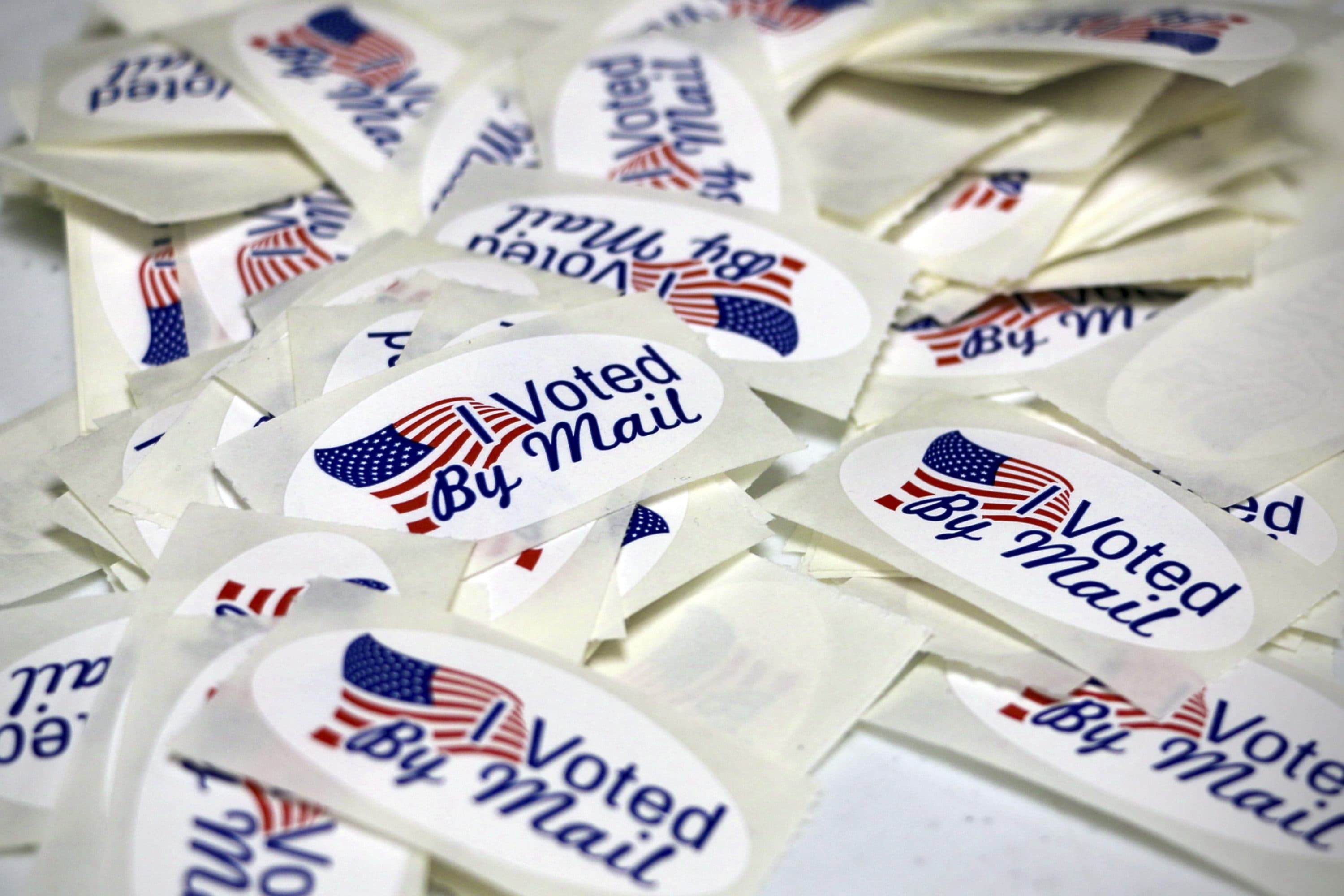 Stickers reading "I Voted By Mail" are displayed as the Wayne County Board of Elections prepares absentee ballots in Goldsboro, N.C., on Sept. 22, 2022. (Hannah Schoenbaum/AP)