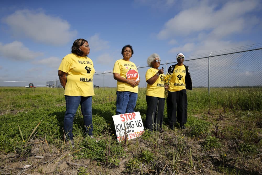 Myrtle Felton, from left, Sharon Lavigne, Gail LeBoeuf and Rita Cooper, members of RISE St. James, conduct a live stream video on property owned by Formosa on March 11, 2020, in St. James Parish, La. The Environmental Protection Agency said it has evidence that Black residents in an industrial section of Louisiana face an increased risk of cancer from a nearby chemical plant and that state officials have allowed air pollution to remain high and downplayed its threat. (Gerald Herbert/AP)