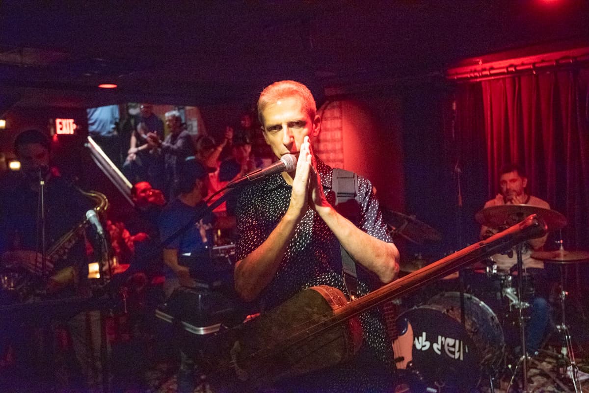 Mike Rivard, bassist and leader of Club d'Elf, speaks to the crowd at the Lizard Lounge's reopening in Cambridge, MA. (Courtesy of Joshua Touster)