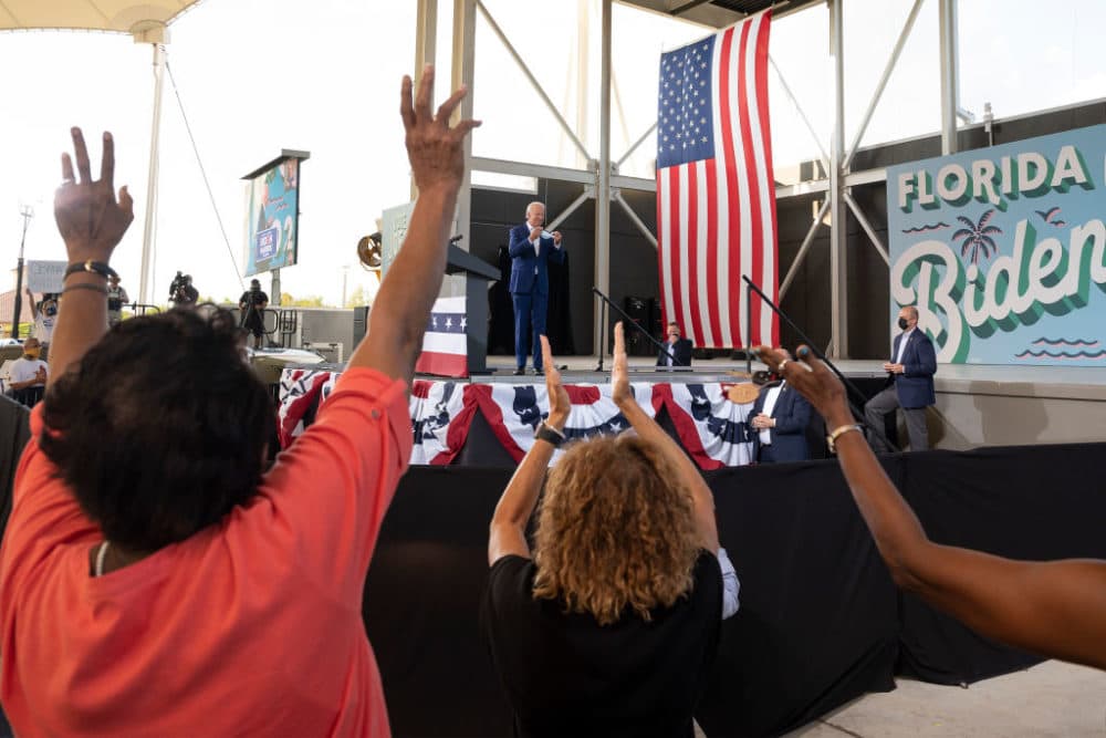 Supporters cheer as Democratic Presidential Candidate Joe Biden speaks during a drive in rally in Miramar, Florida on October 13, 2020. (JIM WATSON/AFP via Getty Images)