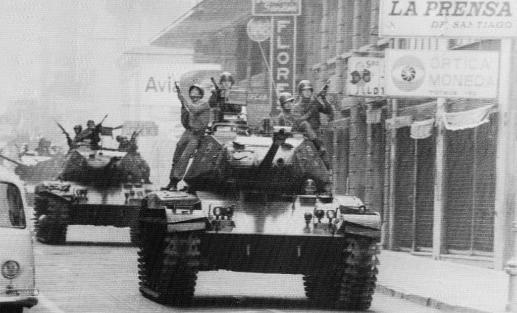 Armed soldiers ride atop tanks in the streets of Santiago here on September 12th, as Army Commander General Augusto Pinochet Pinochet is sworn in as President.