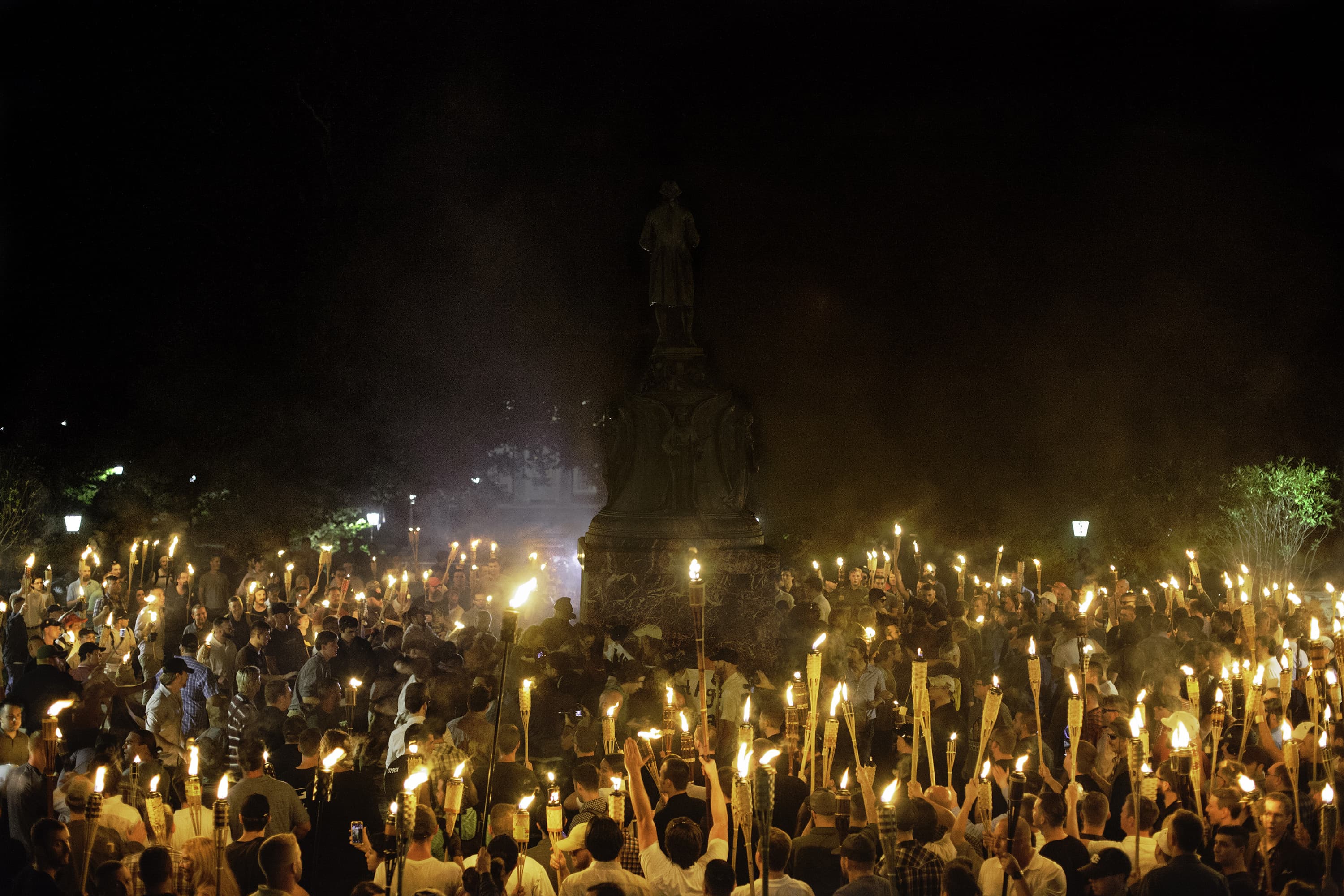 Neo-Nazis and white supremacists encircle counterprotesters at the base of a statue of Thomas Jefferson after marching through the University of Virginia campus with torches in Charlottesville, Va., on Aug. 11, 2017. (Shay Horse/NurPhoto via Getty Images)