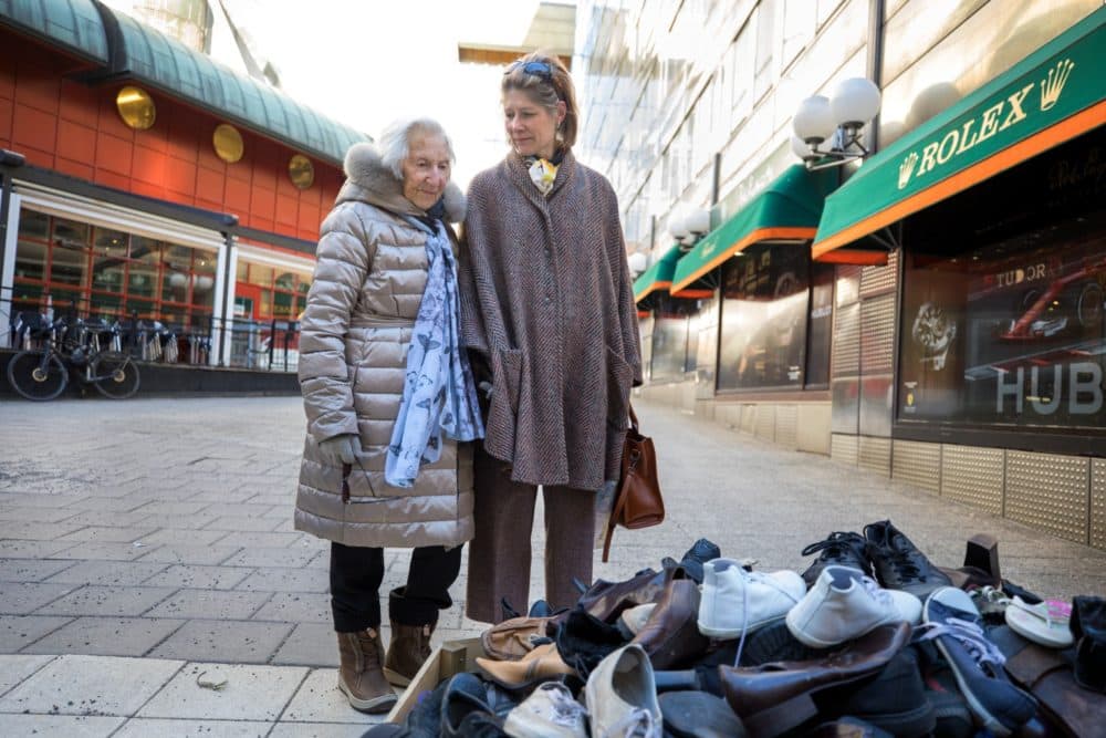 Hedi Fried and the author, Julie Lindahl, pictured in Stockholm, in March 2018. The women helped start a street art project, with a pile of old shoes next to the message #AndISpokeOut -- encouraging people to resist racist violence and white supremacy.  (Paul Hansen/Dagens Nyheter)