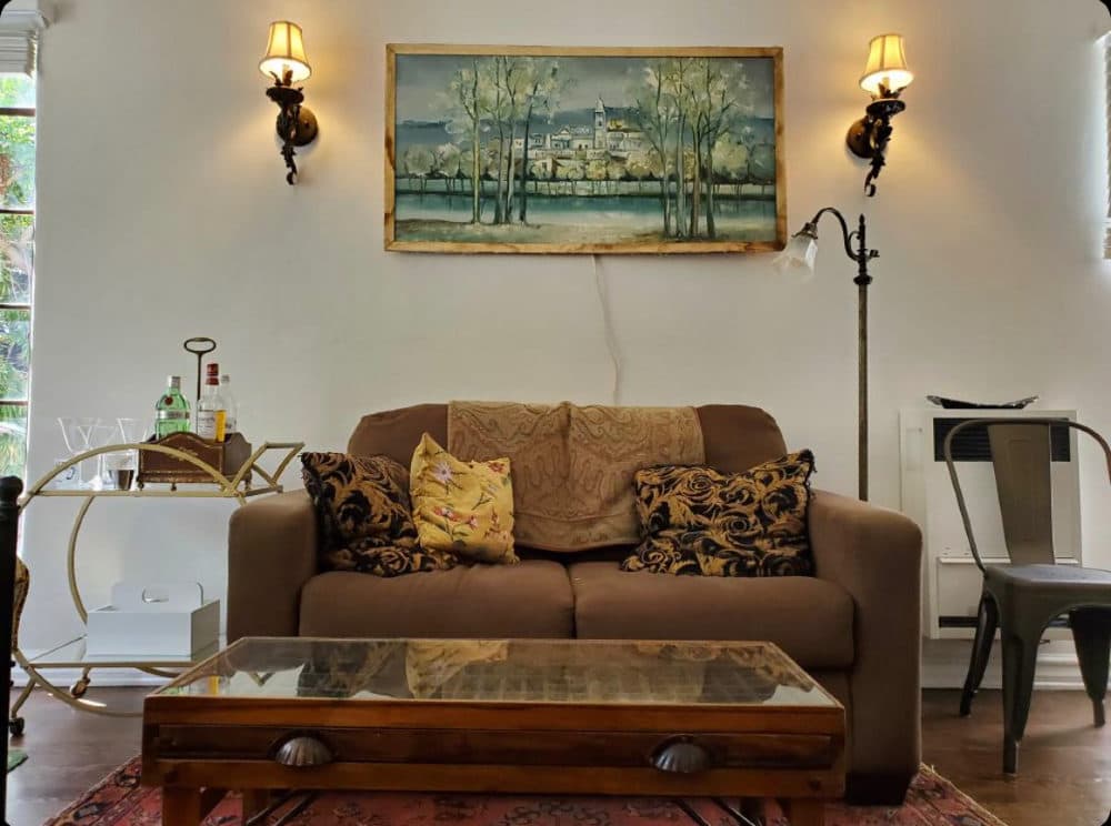 The author's son's furnished living room, complete with vintage bar cart, left, compliments of Facebook Marketplace. (Courtesy Julia Claiborne Johnson)