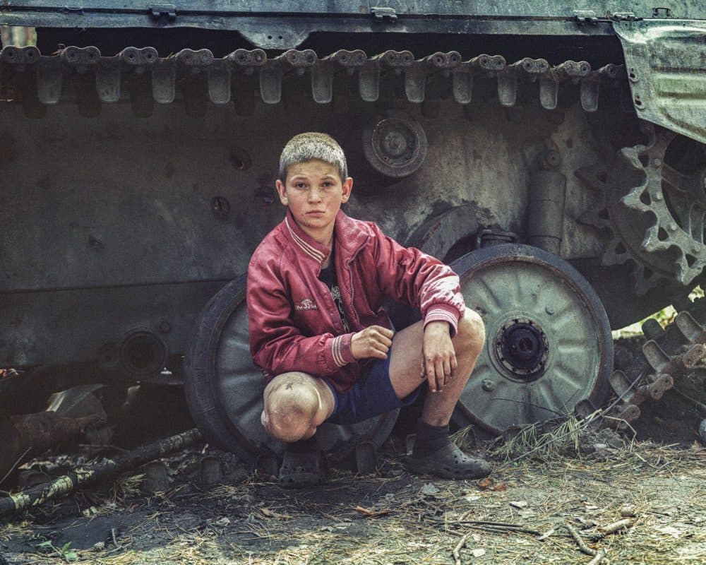 Viktor finds a mine while playing football with friends. (Mark Neville)