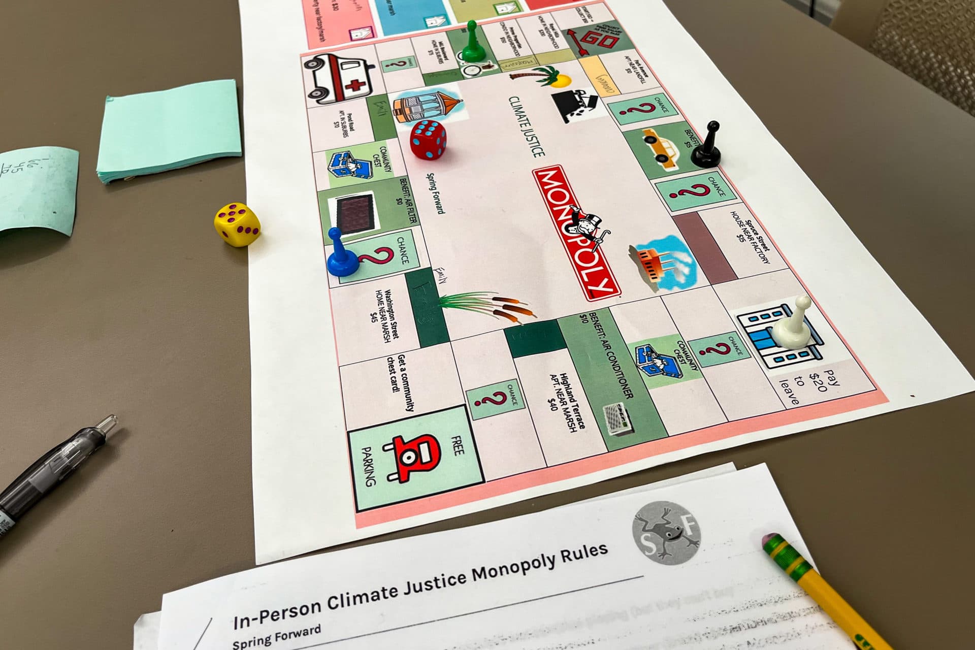 Spring Forward's board game 'Climate Justice Monopoly' teaches students about the financial consequences of climate change. (Aimee Moon/WBUR)
