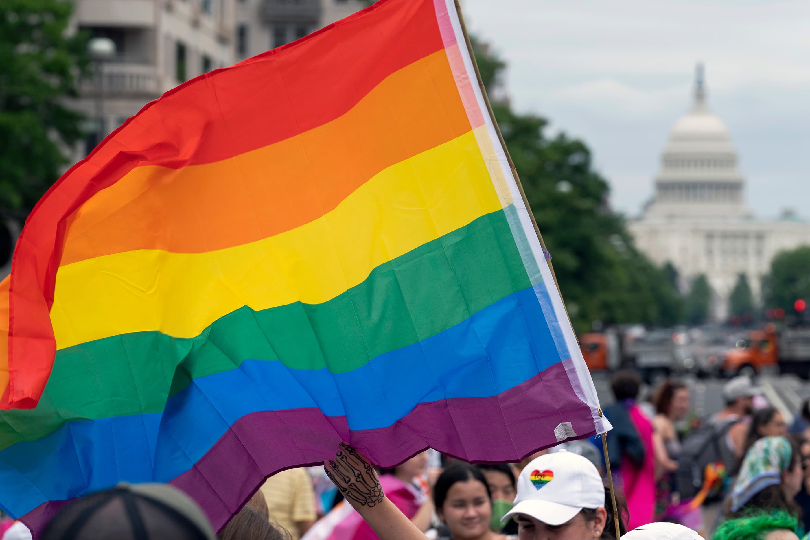 With the U.S. Capitol in the background, a person waves a rainbow flag as they participant in a rally in support of the LGBTQIA+ community. (Jose Luis Magana/AP)