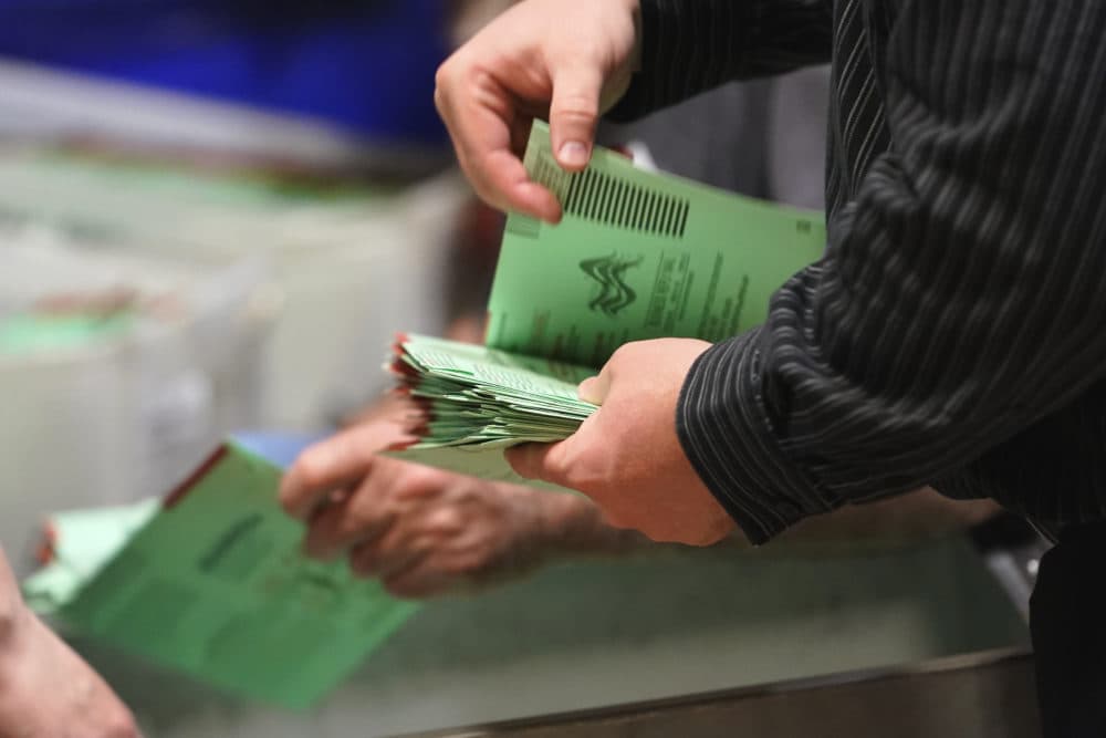 Election workers sort early ballots for signature verification. (Matt York/AP)