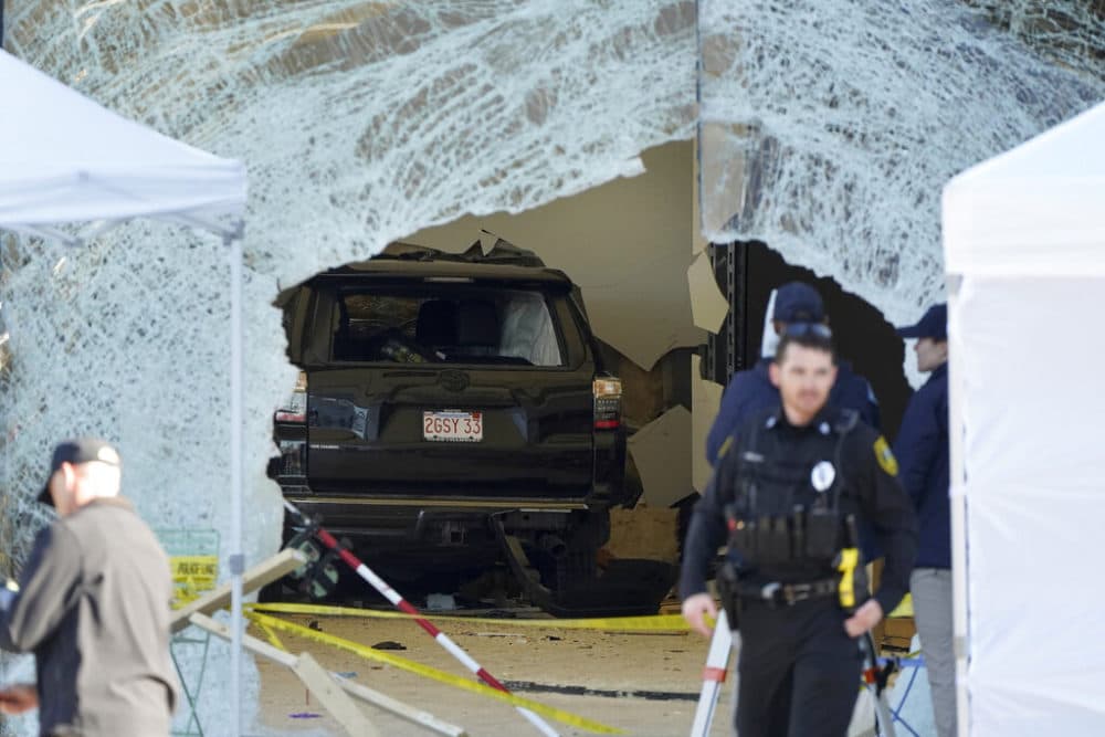 One person was killed and 16 others were injured when the driver of an SUV crashed into an Apple Store in Hingham, authorities said. (Steven Senne/AP)