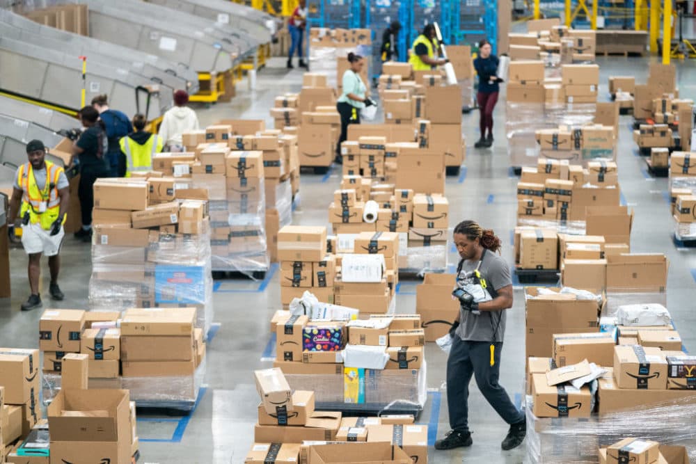 Workers sort packages by zip code during a media tour of the Amazon AGS5 facility on October 27, 2022 in Appling, Georgia. Amazon, the leading United States retail e-commerce company is preparing for the busy winter holiday season and plans to hire hire 150,000 full-time, seasonal and part-time workers to fulfill orders. (Photo by Sean Rayford/Getty Images)
