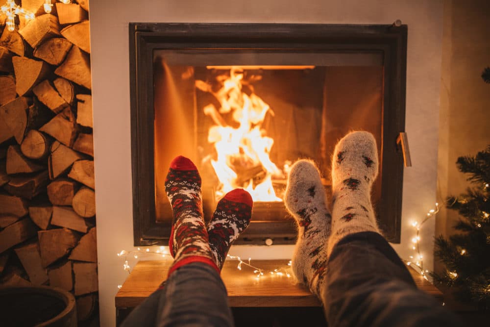 People relax by the fireplace. (Getty Images)